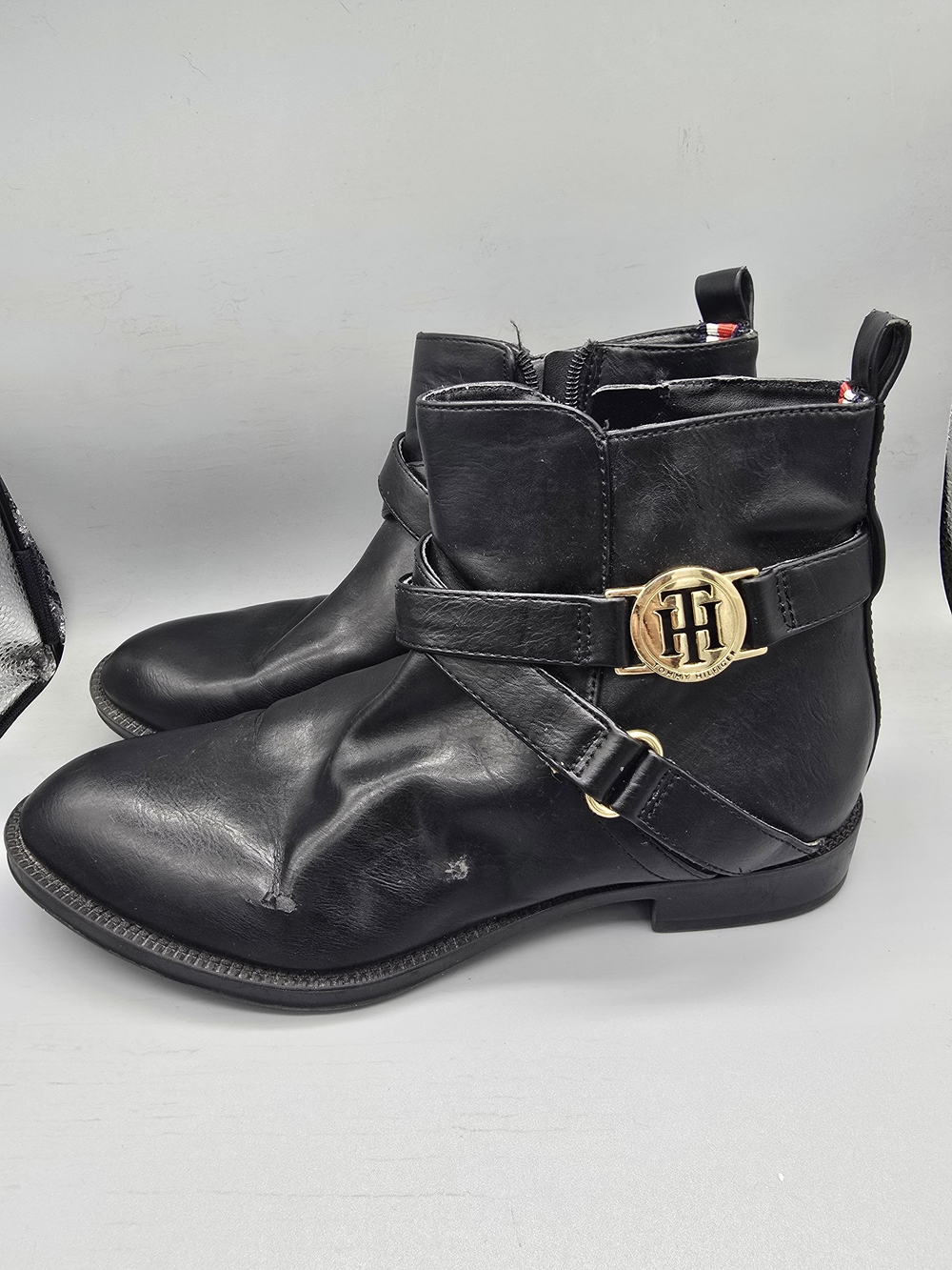 Tommy Hilfiger Women's Black Leather Ankle Harness Boots with Gold Emblem